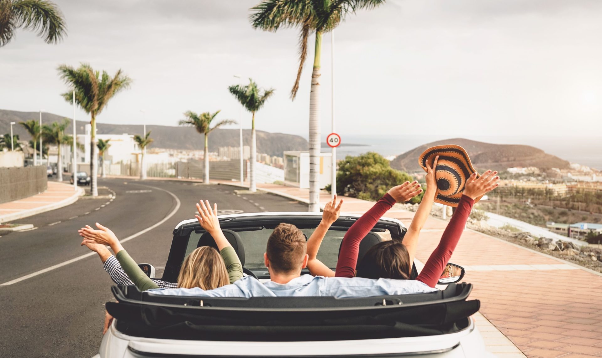 happy-friends-having-fun-in-convertible-car-on-vac-2022-02-25-22-55-18-utc