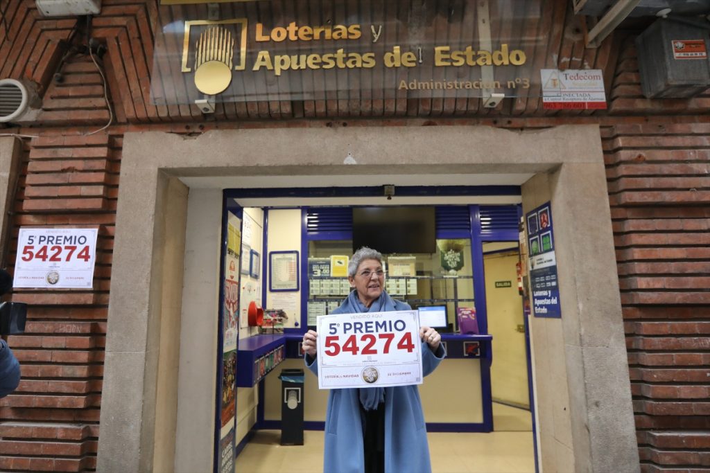 ¡Sigue en directo El Gordo de Navidad en MONCLOA: El Gordo más tardío de la historia, el 88.008! 5 Moncloa La lotera de la administración de la calle Padre Tomás Lorenzo, muestra un cartel con uno de los quintos premios del Sorteo.