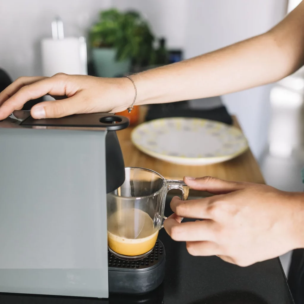 close up woman taking coffee from coffee machine Moncloa