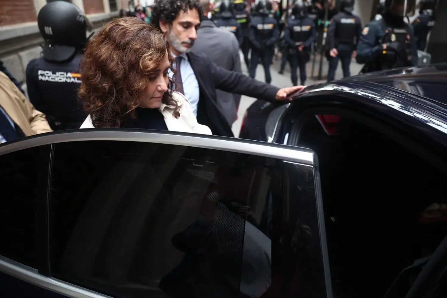 Isabel Díaz Ayuso a la salida del acto del día 19 protegida por la Policía Nacional. Foto: Agencias